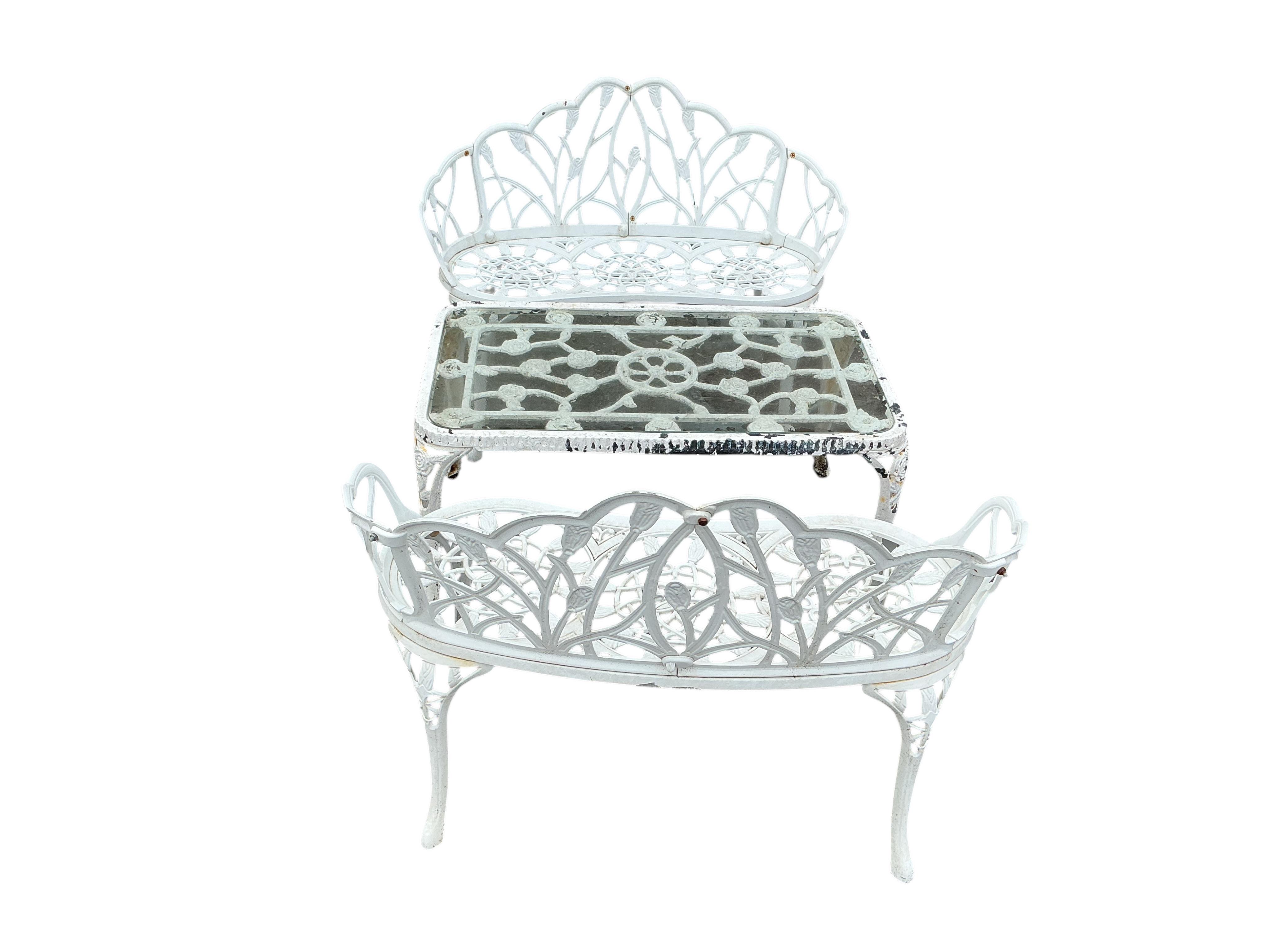 A pair of white painted aluminium garden benches, width 100cm, height 78cm and a similar rectangular glass topped table